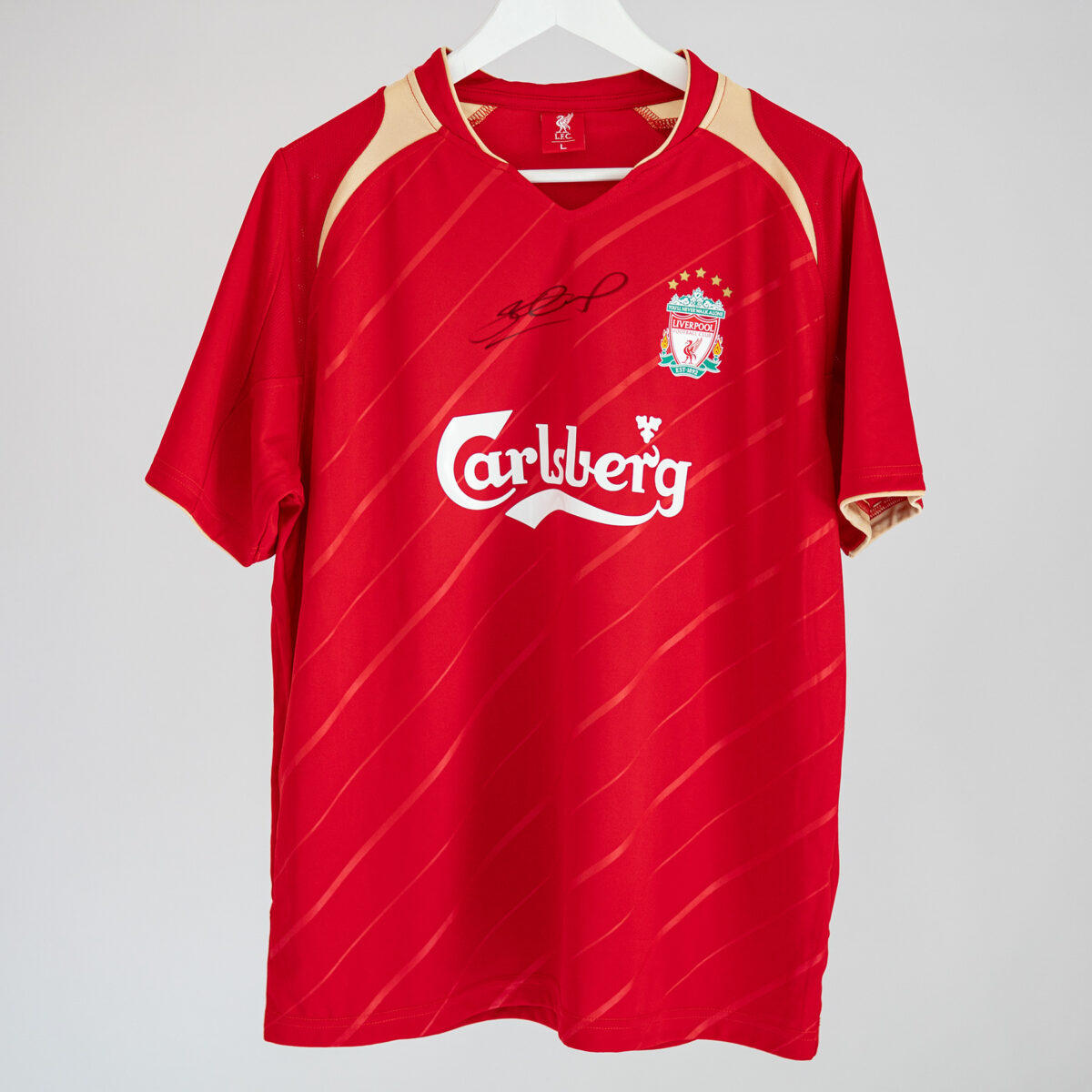 Official Liverpool FC reproduction of the 2005/06 European home shirt personally hand signed by Steven Gerrard.